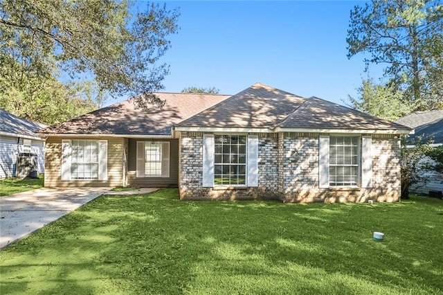 single story home with concrete driveway, a front lawn, and a shingled roof