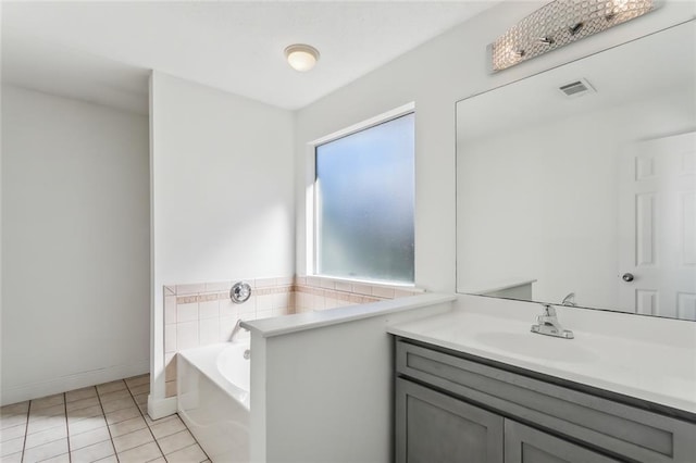 bathroom featuring vanity, visible vents, baseboards, tile patterned flooring, and a bath