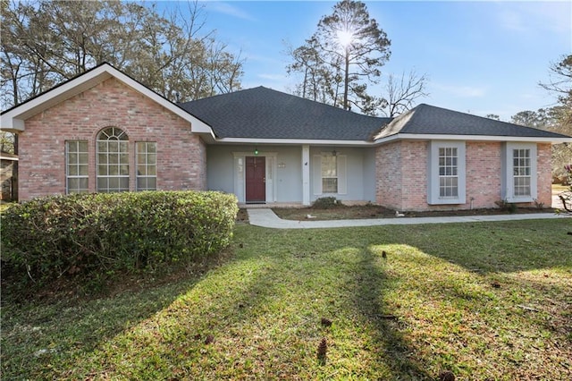 ranch-style home with a front lawn, brick siding, and a shingled roof