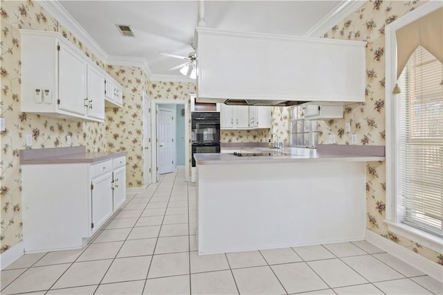 kitchen with light tile patterned floors, a ceiling fan, wallpapered walls, a peninsula, and dobule oven black