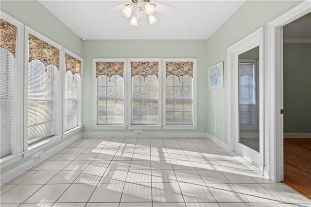 unfurnished sunroom with a ceiling fan