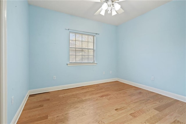 unfurnished room with baseboards, light wood-style floors, and ceiling fan