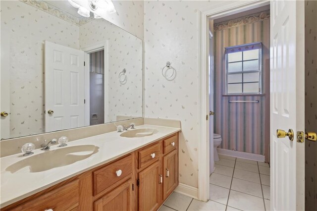 105 Cherokee Dr, Abita Springs, LA 70420 - bathroom featuring double vanity, tile patterned flooring, toilet, and wallpapered walls
