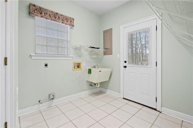 washroom with light tile patterned floors, baseboards, hookup for an electric dryer, hookup for a washing machine, and laundry area