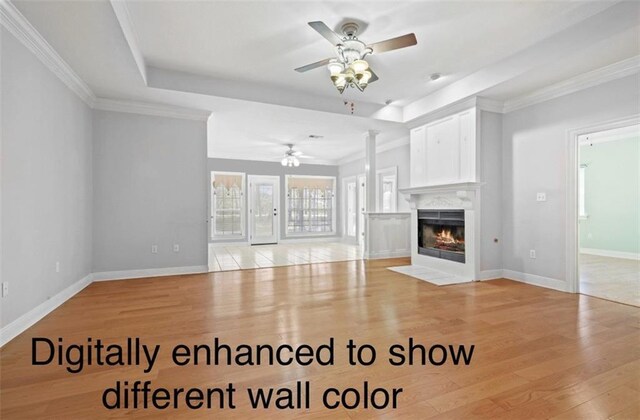 105 Cherokee Dr, Abita Springs, LA 70420 - unfurnished living room featuring ceiling fan, light wood-style flooring, a tiled fireplace, baseboards, and crown molding
