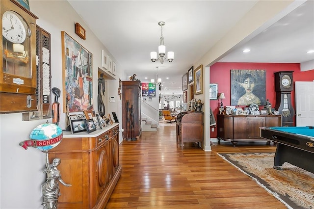 interior space with recessed lighting, a notable chandelier, wood finished floors, and stairs