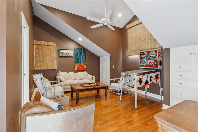 recreation room featuring baseboards, high vaulted ceiling, light wood-style flooring, recessed lighting, and ceiling fan