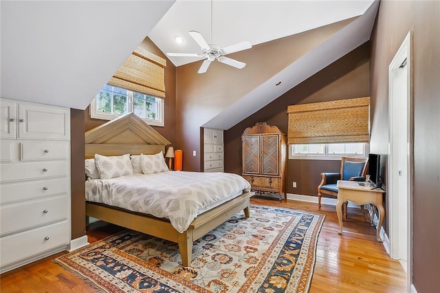 bedroom with vaulted ceiling, a ceiling fan, baseboards, and light wood finished floors