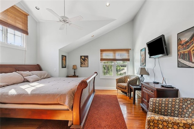 bedroom with multiple windows, wood finished floors, recessed lighting, and high vaulted ceiling