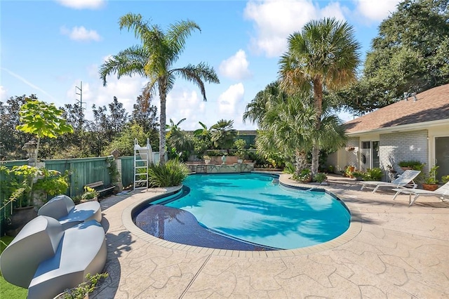 view of swimming pool featuring fence, a patio area, and a fenced in pool