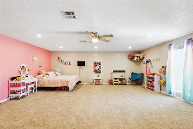 carpeted bedroom with recessed lighting, visible vents, a textured ceiling, and a ceiling fan