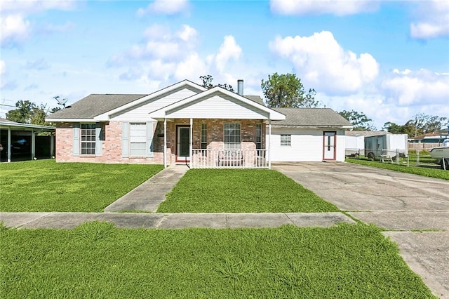 view of front of home featuring a front yard, fence, driveway, covered porch, and brick siding