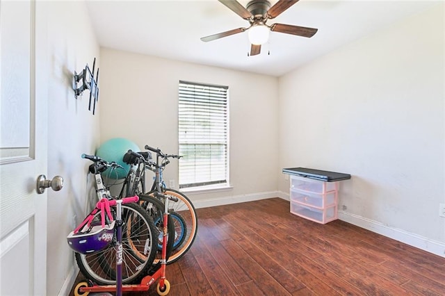 miscellaneous room with a ceiling fan, baseboards, and hardwood / wood-style flooring