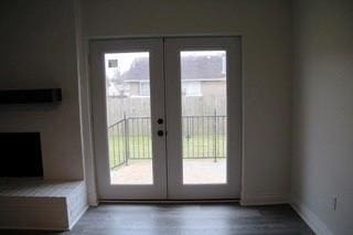 doorway to outside featuring french doors, baseboards, and wood finished floors