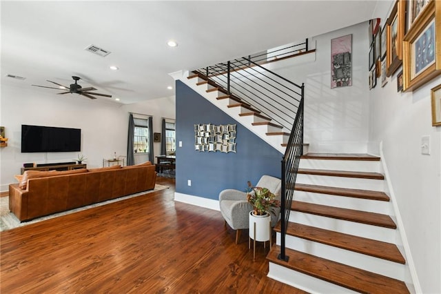 stairway featuring recessed lighting, wood finished floors, visible vents, and baseboards