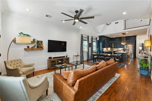 living room featuring a ceiling fan, visible vents, dark wood finished floors, lofted ceiling, and recessed lighting