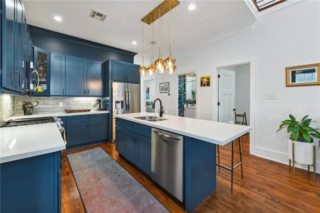 kitchen featuring visible vents, blue cabinetry, appliances with stainless steel finishes, and a sink