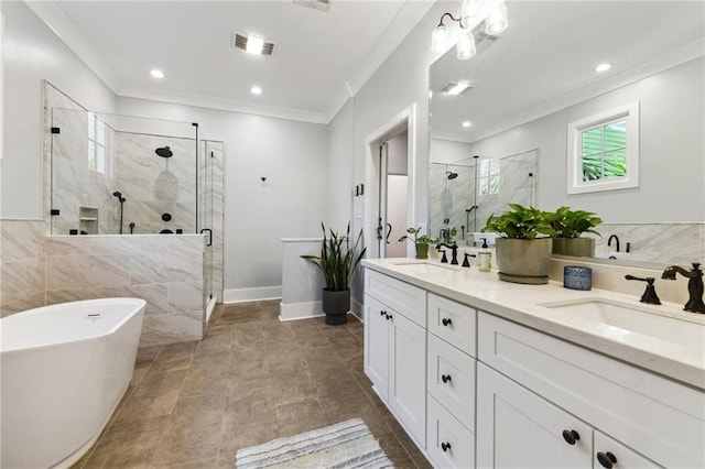 bathroom with a shower stall, crown molding, visible vents, and a sink