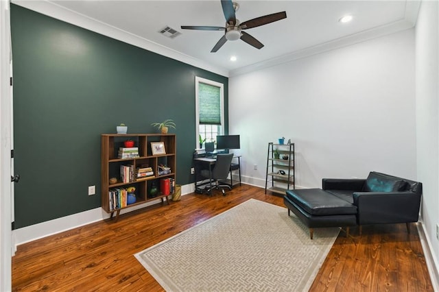 home office featuring visible vents, crown molding, ceiling fan, baseboards, and wood finished floors