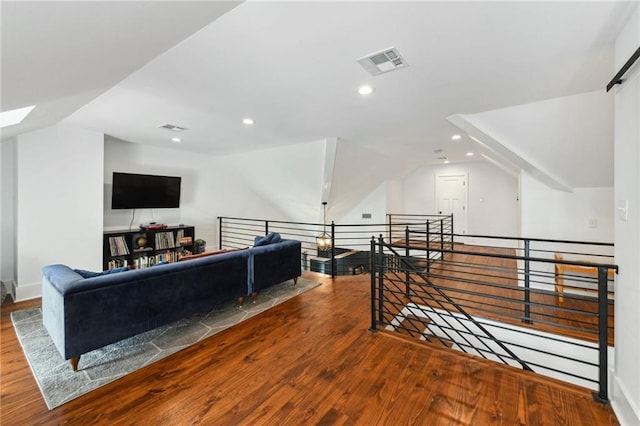 bonus room with lofted ceiling, recessed lighting, wood finished floors, and visible vents