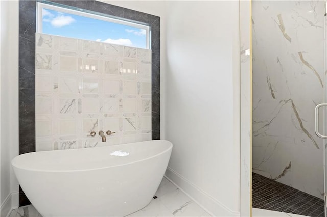 full bath with tile walls, a freestanding tub, marble finish floor, and a marble finish shower