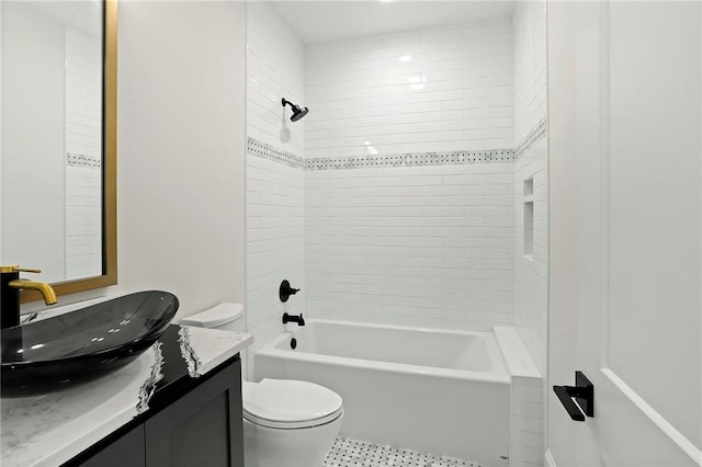 bathroom with toilet, vanity, and shower / tub combination