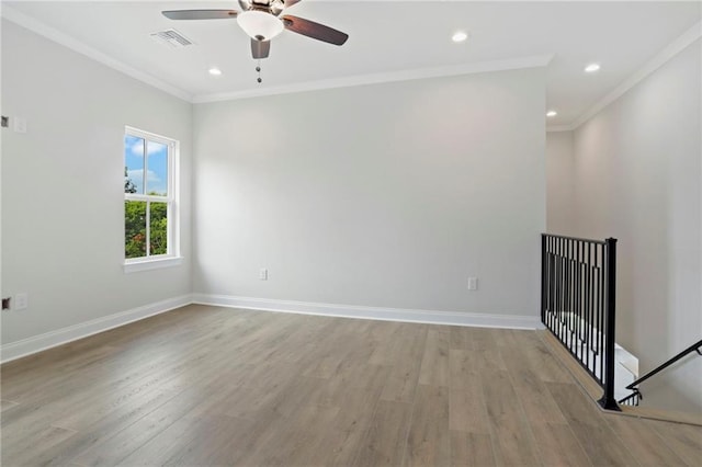 unfurnished room with light wood-type flooring, visible vents, and baseboards