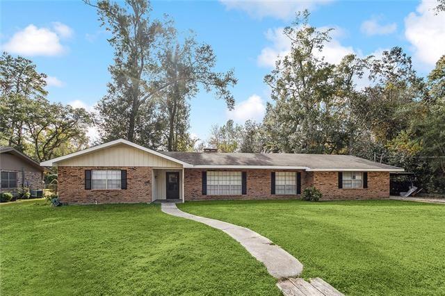 ranch-style home with brick siding and a front lawn