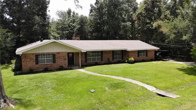 309 E 5th Ave, Covington, LA 70433 - ranch-style home with a front yard, brick siding, and a chimney