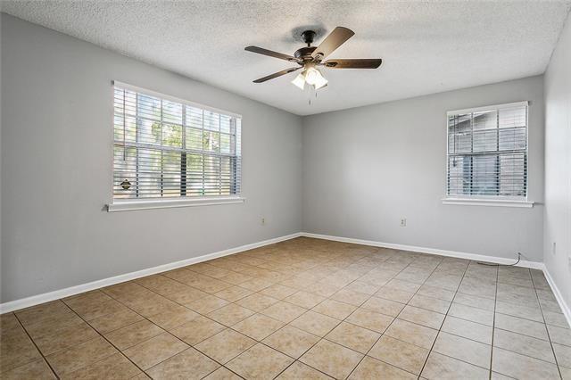 unfurnished room with baseboards, a textured ceiling, ceiling fan, and light tile patterned flooring