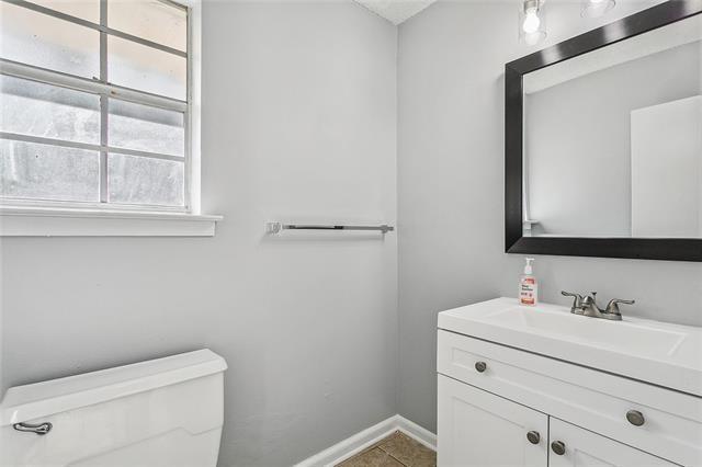 bathroom with tile patterned floors, toilet, vanity, and baseboards