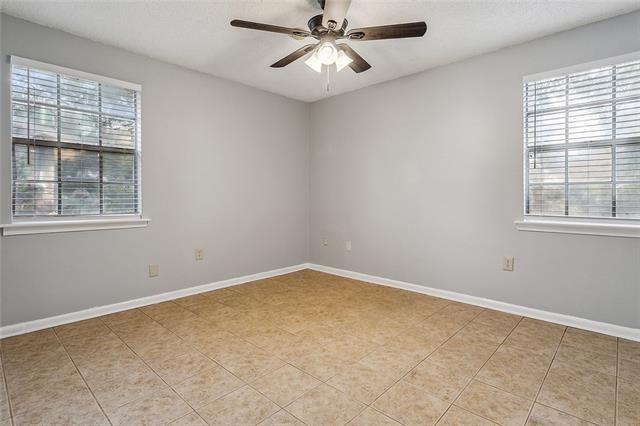 309 E 5th Ave, Covington, LA 70433 - empty room with a ceiling fan and light tile patterned floors