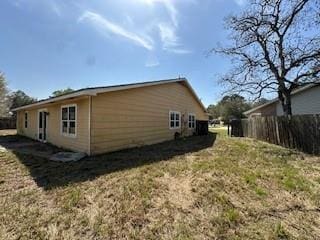 view of side of property featuring fence