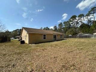 rear view of property featuring a lawn