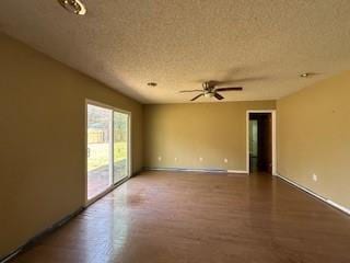 unfurnished room with baseboards, a textured ceiling, and a ceiling fan