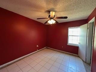 empty room featuring baseboards, a textured ceiling, ceiling fan, and light tile patterned flooring