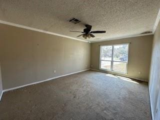 carpeted spare room featuring visible vents, baseboards, ornamental molding, a textured ceiling, and a ceiling fan