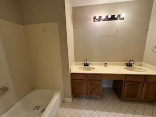 full bathroom with tile patterned flooring, double vanity, a washtub, and a sink