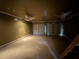 garage with baseboards, visible vents, and ceiling fan