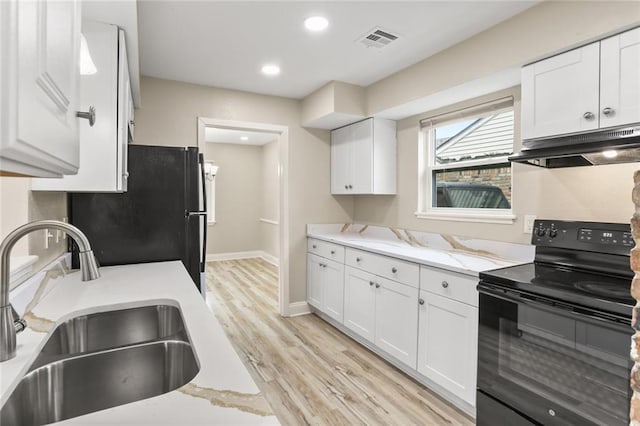 kitchen featuring visible vents, black appliances, under cabinet range hood, a sink, and white cabinets