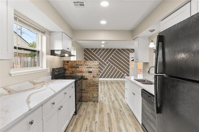 kitchen with visible vents, black appliances, a sink, under cabinet range hood, and light wood-style floors