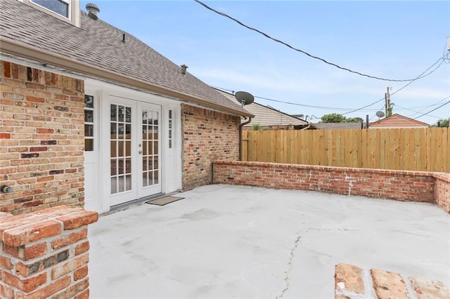 view of patio featuring french doors and fence