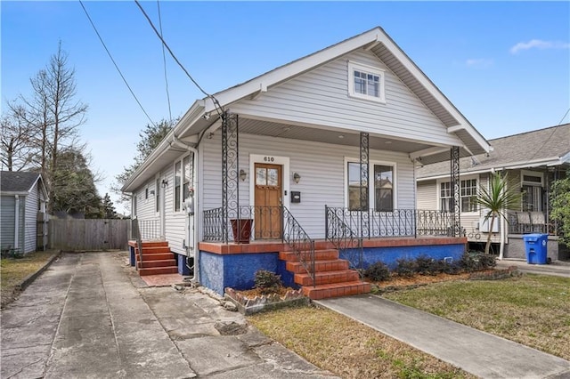 view of front facade featuring a porch and fence