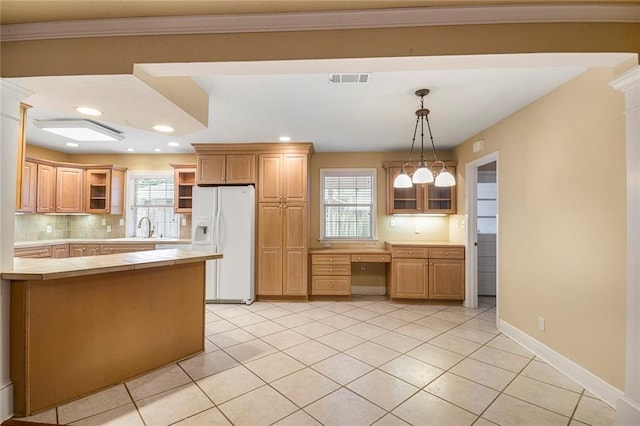 kitchen with tile countertops, open shelves, a sink, white refrigerator with ice dispenser, and built in desk