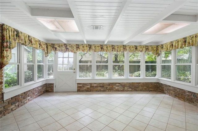 unfurnished sunroom with beamed ceiling and visible vents