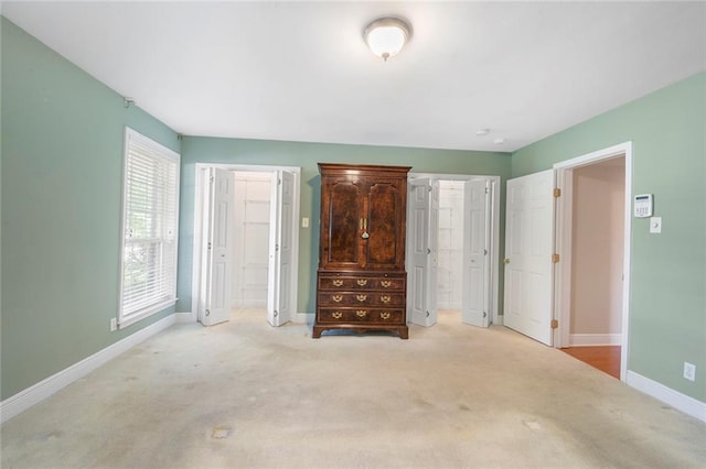 unfurnished bedroom featuring carpet flooring and baseboards