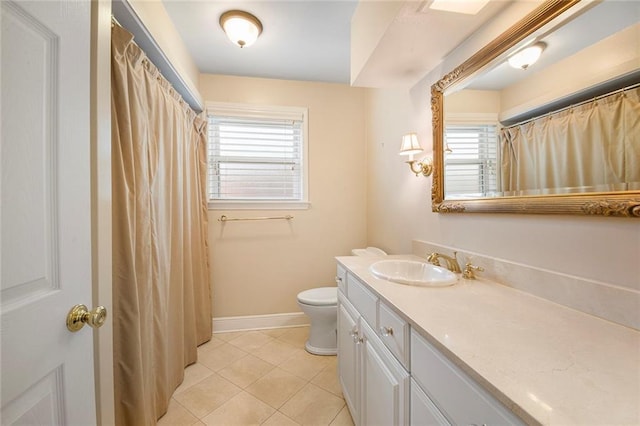 full bathroom with vanity, tile patterned floors, toilet, and baseboards