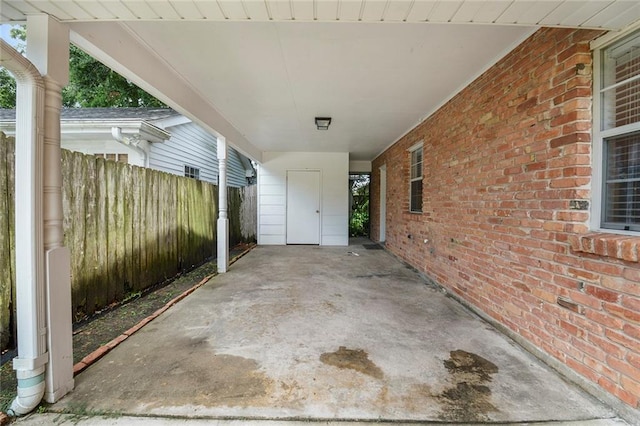 view of patio / terrace featuring a carport and fence