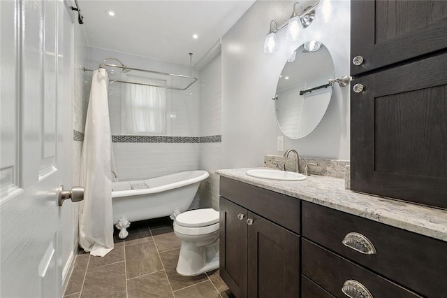 bathroom featuring tile patterned flooring, toilet, vanity, and shower / bath combo with shower curtain