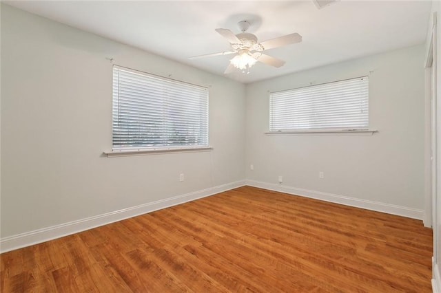 empty room with light wood-type flooring, baseboards, and a ceiling fan